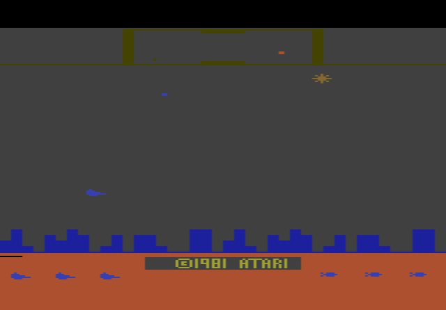 Defender on the 2600: the player's ship flying over the city skyline, with alien Landers above and the scanner at the top