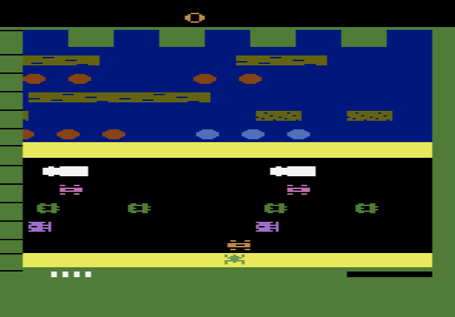 A frog riding a floating log across the river in Frogger, close to the screen edge