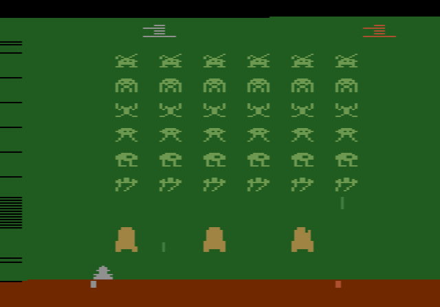 Rows of invaders above three shields and the laser cannon in Space Invaders